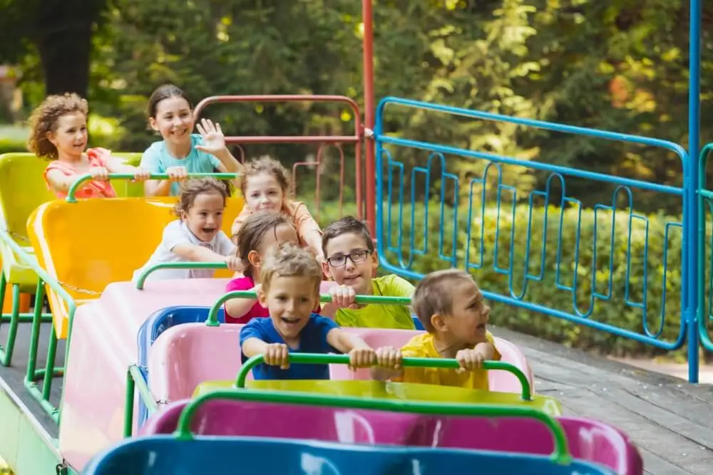 Children having fun on a mini roller coaster ride at Dutch Wonderland.
