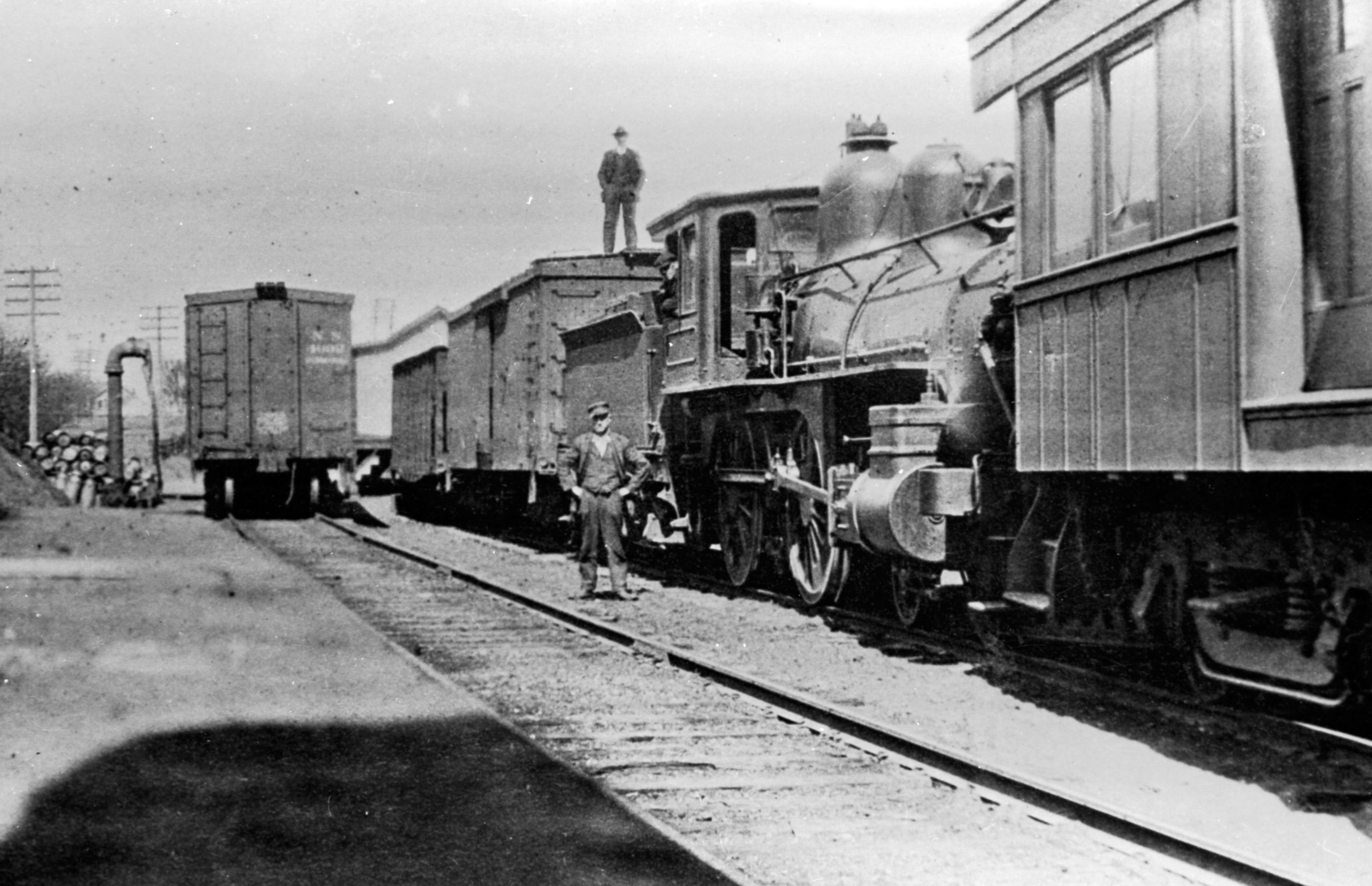 an old photo of a train on a steel track