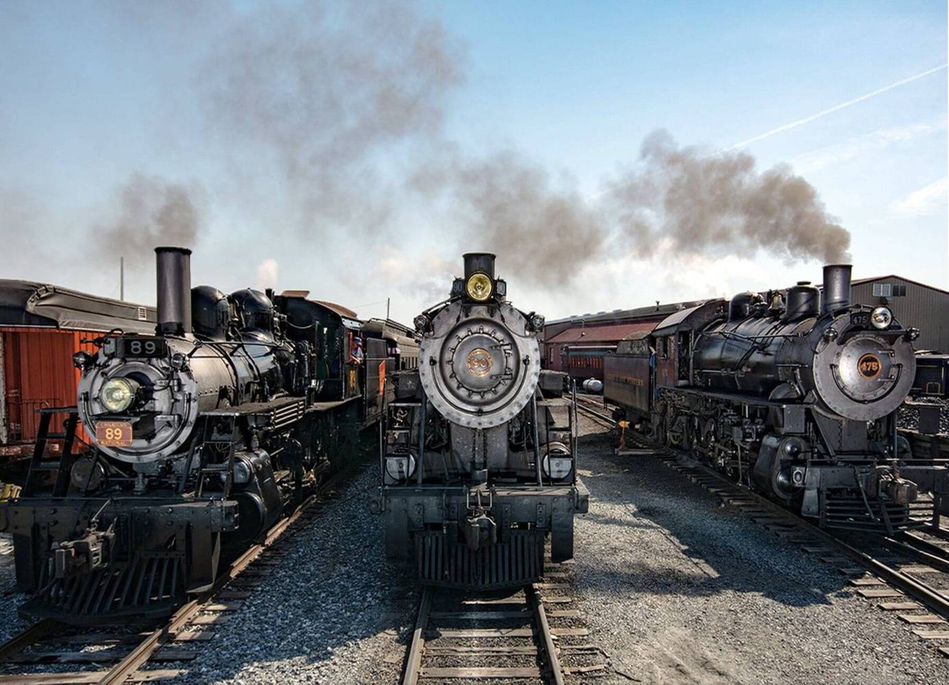 3 steam engines on the train tracks at Strasburg Rail Road.
