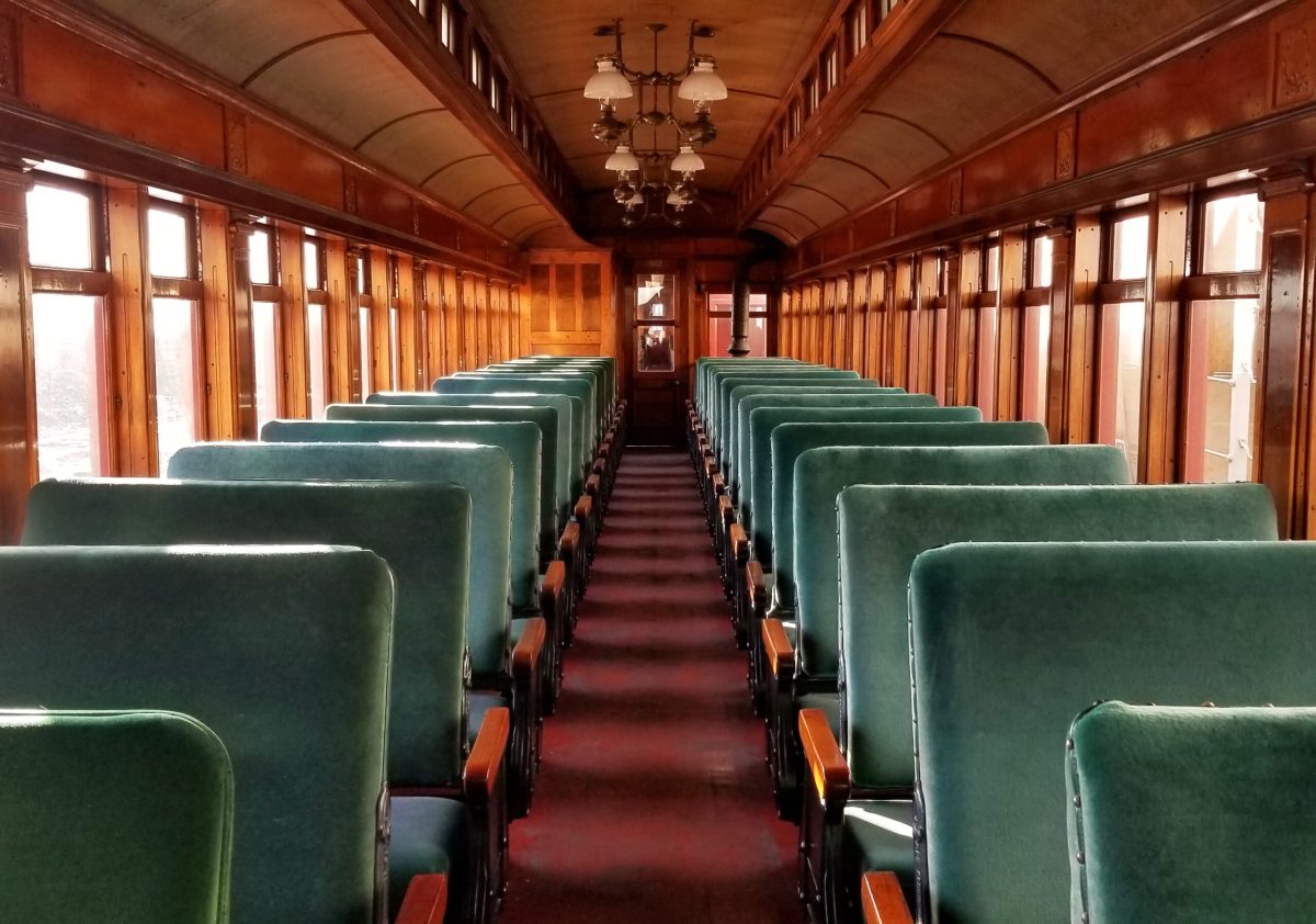 20230127_152025 copy Rows of empty bench seating on a train.