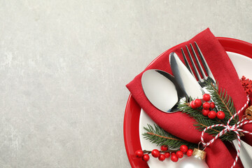 The edge of a holiday themed place setting with silverware.