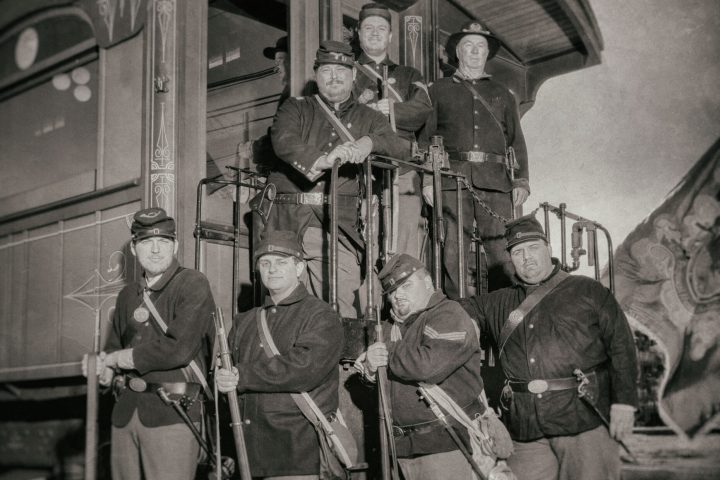 Civil War Days: a group of people standing next to or on the end of a train.