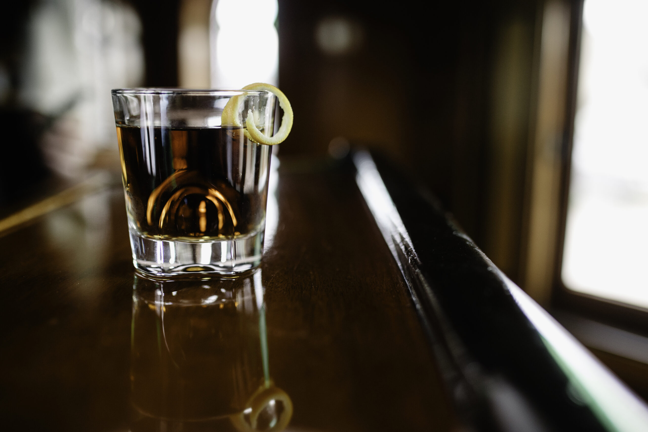 A close-up of a whisky glass on a table.
