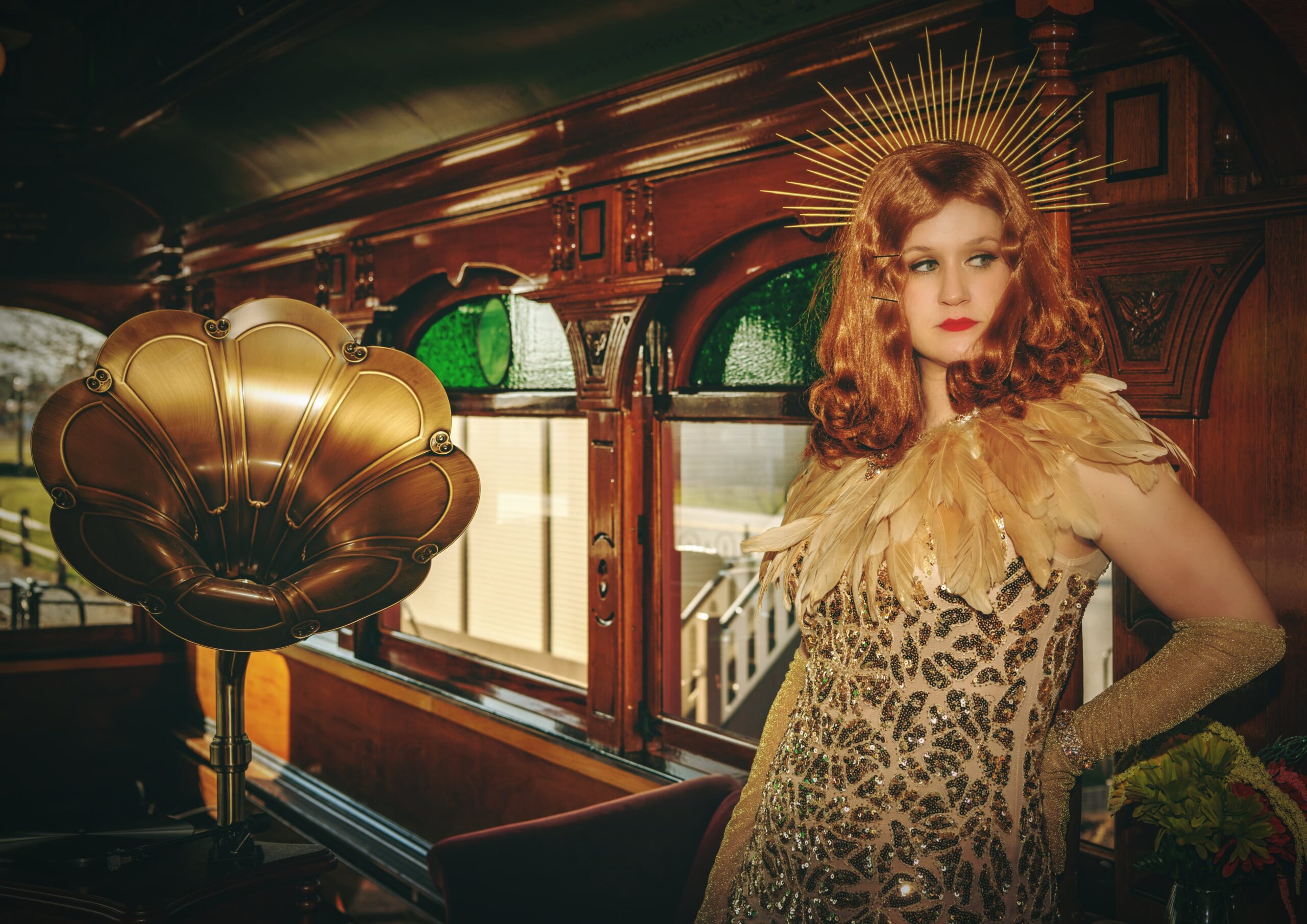 An actress standing in a train car room.