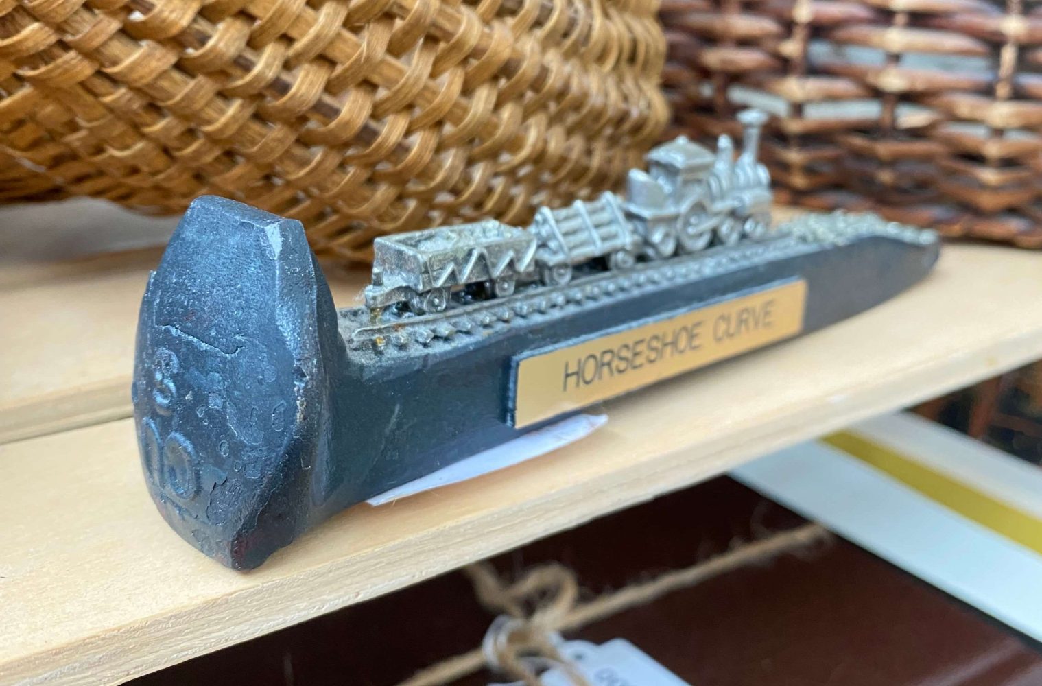 a close up of a railroad spike that's been transformed into art
