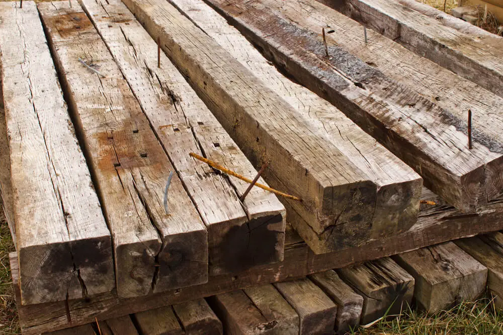 railroad-ties-stacked Wooden railroad ties stacked in a pile with nails facing up.